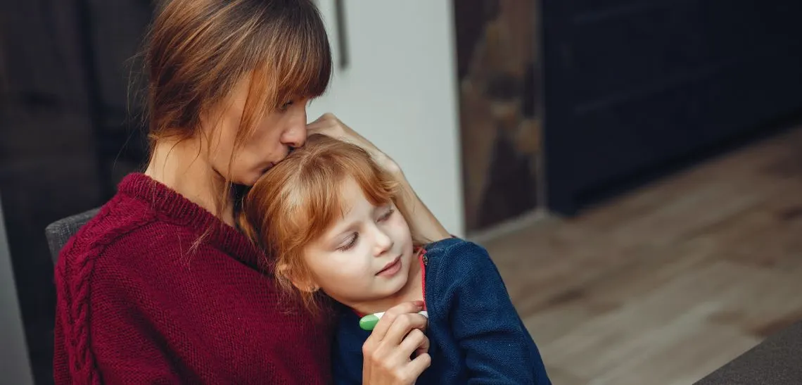 Foster parent comforting a child during emotional moment at home – trauma-informed care in Oklahoma